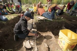Jackson Hole Middle School eighth-grader Jerry Henderson works to dig out a prehistoric fire hearth at an archaeological site at the Linn Canyon Ranch in Teton Valley, Idaho. The students are digging as part of their instruction in local history.