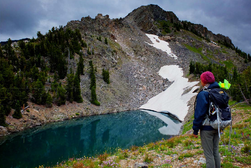 Rebecca Sgouros surveys an alpine lake in the northern Tetons